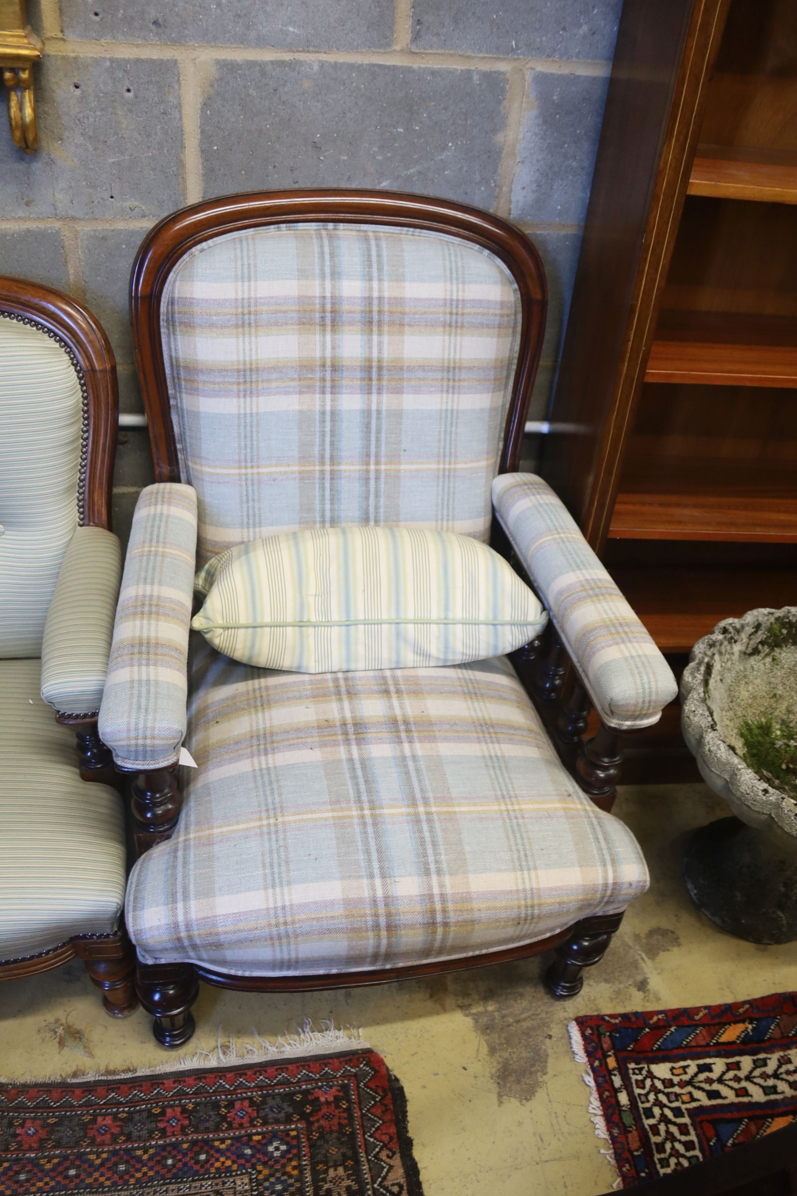 A pair of Victorian mahogany upholstered spoon back armchairs, larger width 68cm, depth 80cm, height 92cm